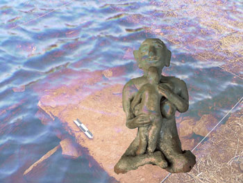 Archeological dig underwater with ancient mother figure