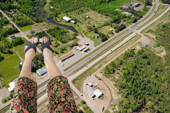 A woman's feet above an aerial landscape