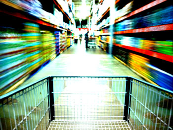 Shopping cart flying down a brightly lit blurry aisle