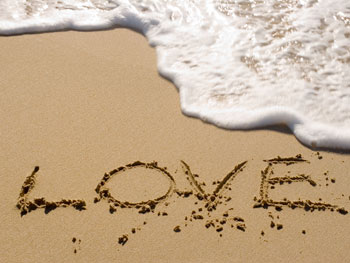 Beach with sand and love written