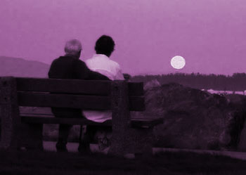 Couple watching moon on bench, with purple tint