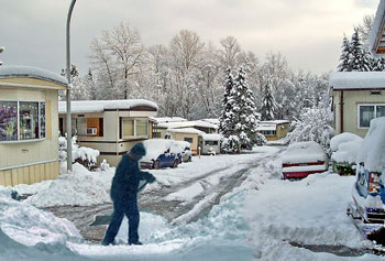 Man shoveling in trailer park