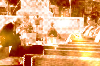 Couple talking at outdoor cafe, pixelated with color distortion