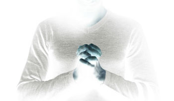 Woman praying, in negative