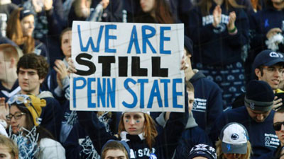 Student holding sign reading 'We are still Penn State'