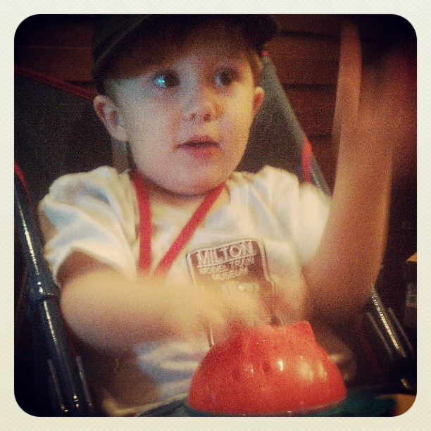 Small boy drumming on bowl