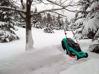 Snowy yard with lawn mower