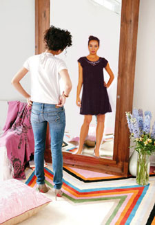 Woman seeing different version of self in mirror