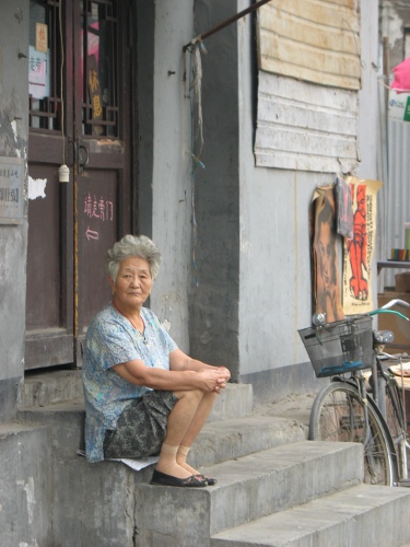Woman in Hutong on steps