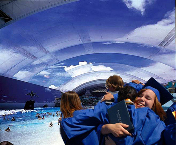 Graduates embracing in front of an artificial inside beach