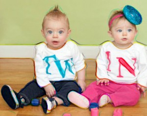 Twin boy and girl with girls that read "tw" and "in"