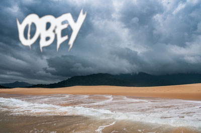 Cloudy sky with "obey" in clouds