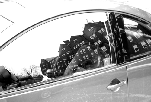 Photo of a reflection of buildings in a car window