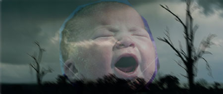 Crying baby interposed on a dark sky
